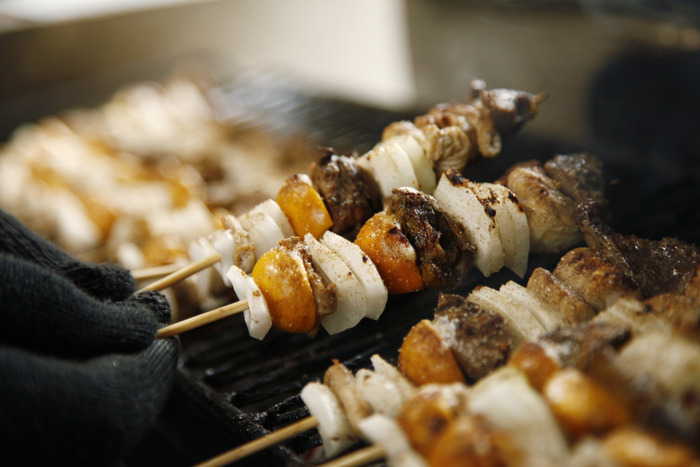 焼き鳥を焼いている様子を正面から写した画像